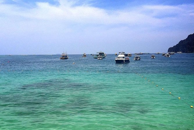 Full Day Phi Phi Islands Tour By Royal Jet Cruiser From Phuket - Stop 1: Ko Phi Phi Le and the big bay lineup you can spot from the water